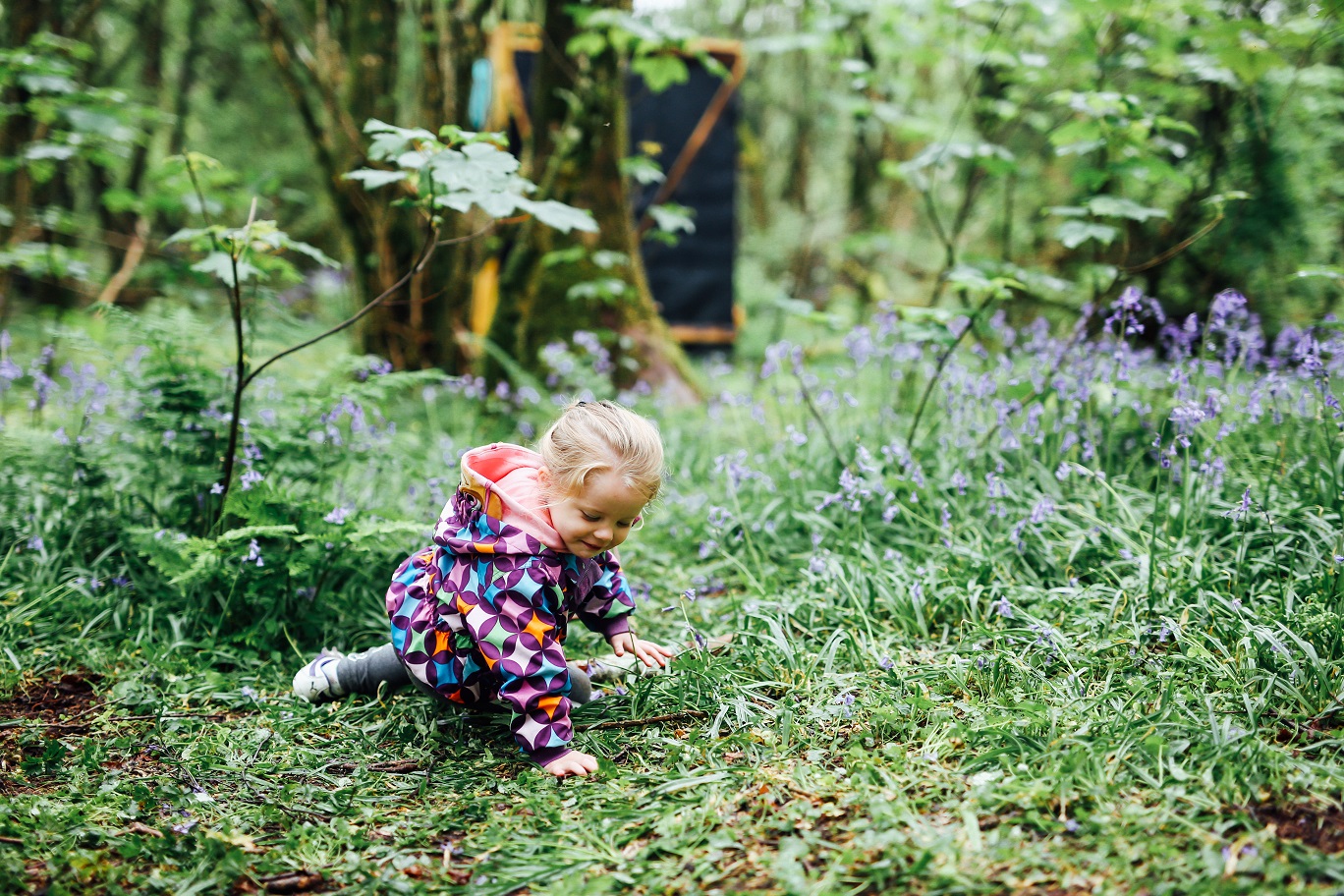 Forest School   girl playing in flowers