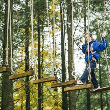 Kids TTA   girl in blue on wooden plank ropes
