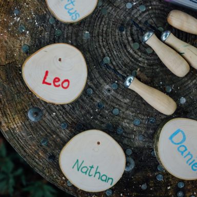 Forest School kids names drawn on wooden pieces